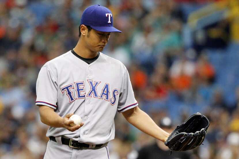 Texas Rangers starting pitcher Yu Darvish (11) reacts on the mound before he throws a pitch...