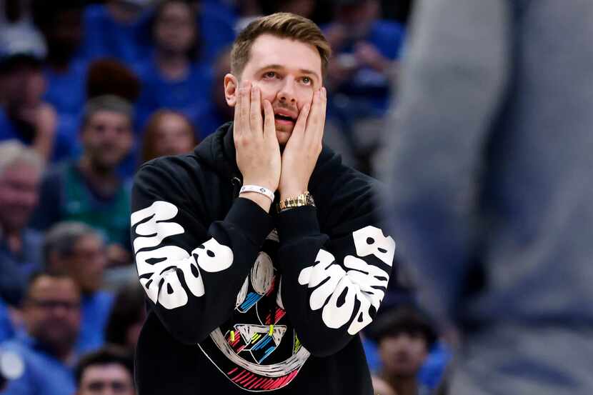 Injured Dallas Mavericks guard Luka Doncic reacts to a second half call in Game 1 of an NBA...