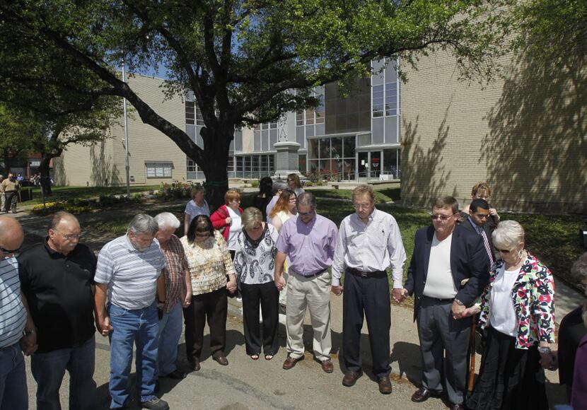 Residents pray during a prayer walk around the Kaufman County Courthouse in Kaufman, Texas...