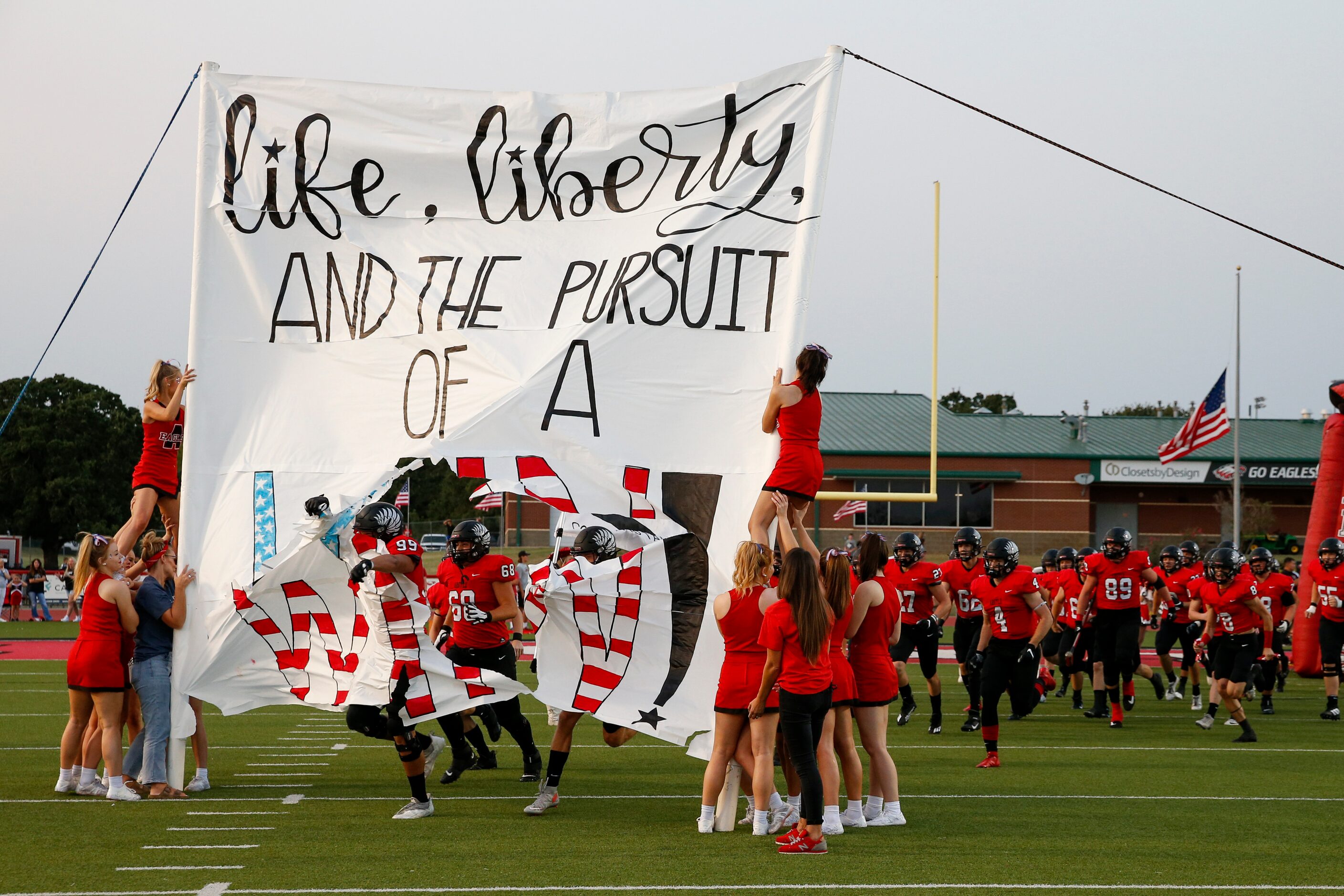 The Argyle football team takes the field before the first half of a high school football...