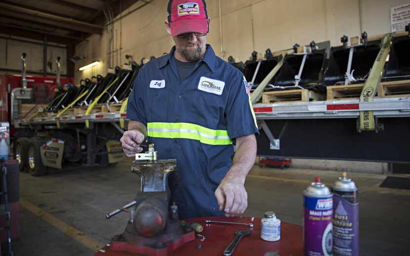 
Jeff Wilson, an employee at Lone Star Transportation, works near a flatbed trailer full of...
