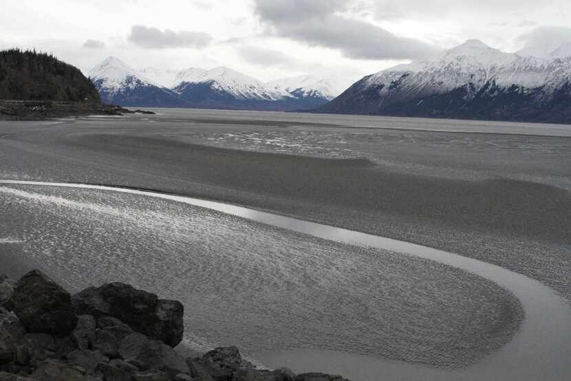 A ribbon of water cuts through the mud flats of Cook Inlet, just off the shore of Anchorage,...