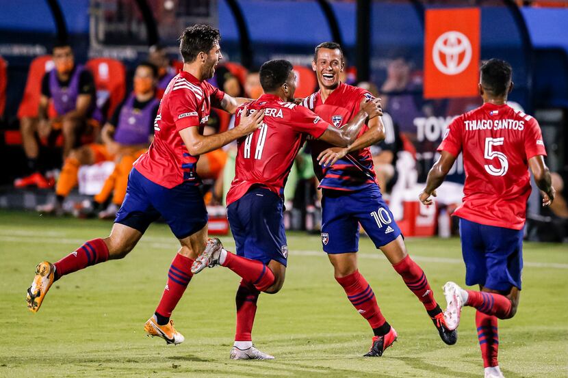 FC Dallas midfielder Ricaurte Velez (10) is congratulated by teammates after scoring a goal...
