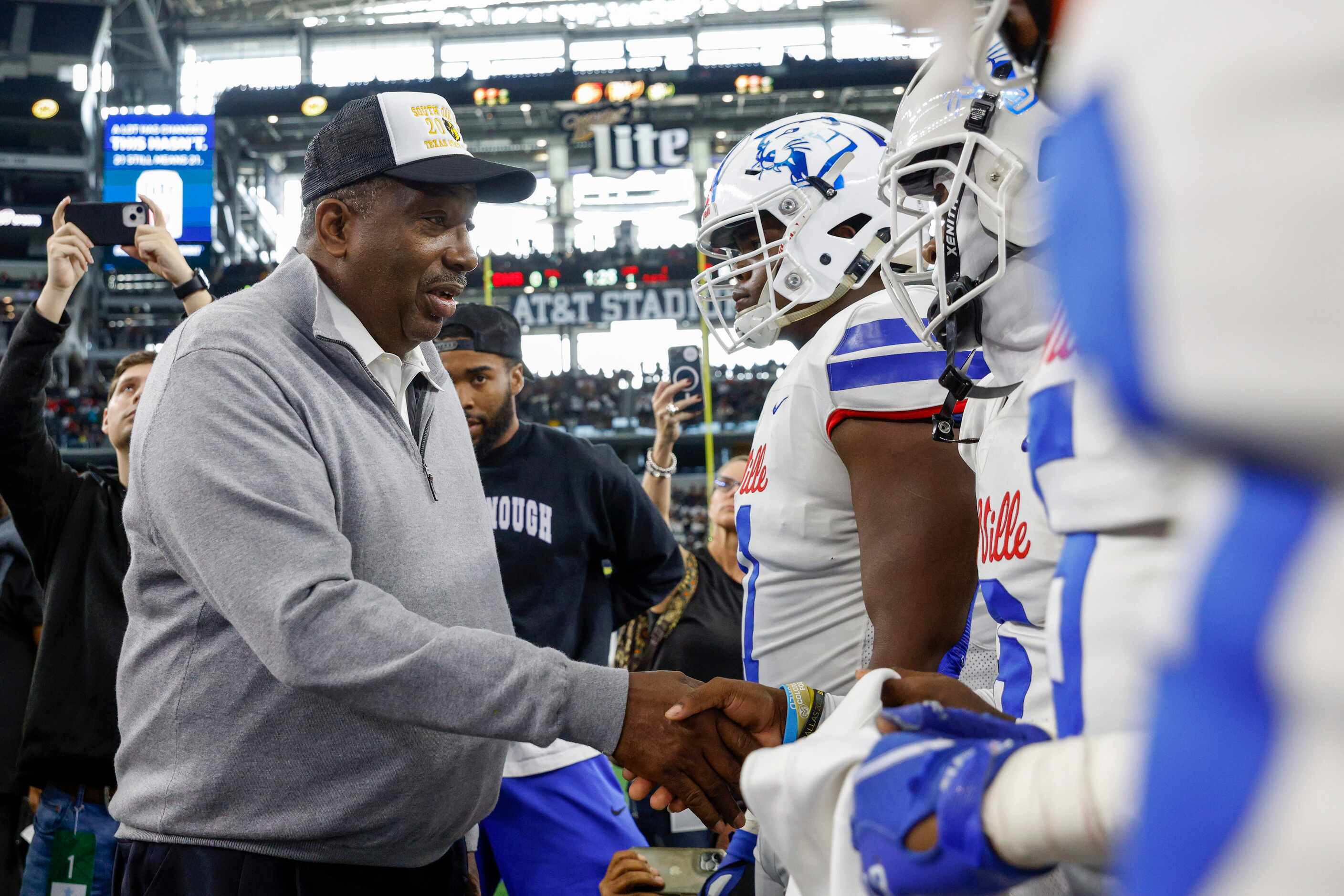 State Sen. Royce West greets the Duncanville captains before the coin toss at the Class 6A...