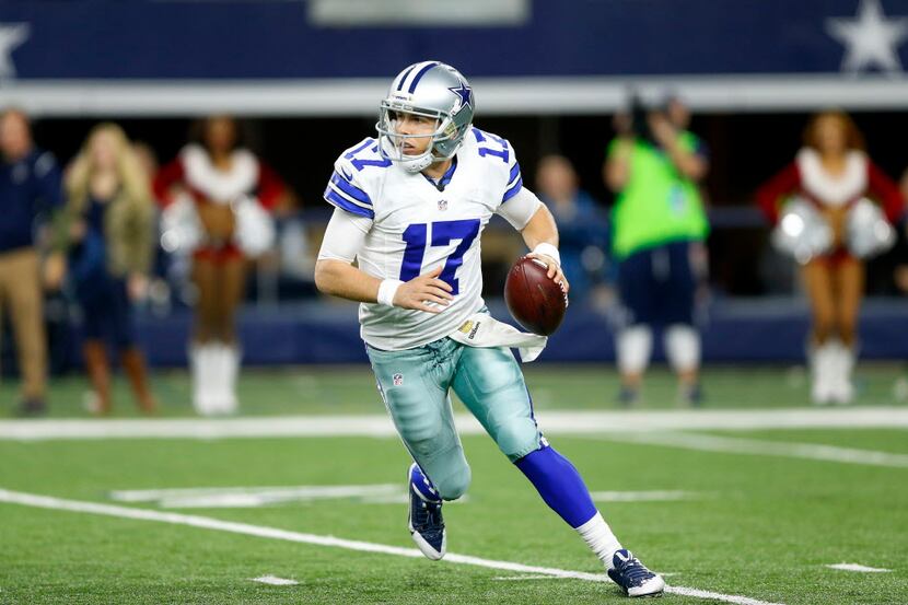 Dallas Cowboys quarterback Kellen Moore (17) scrambles from the pocket as he looks to make a...