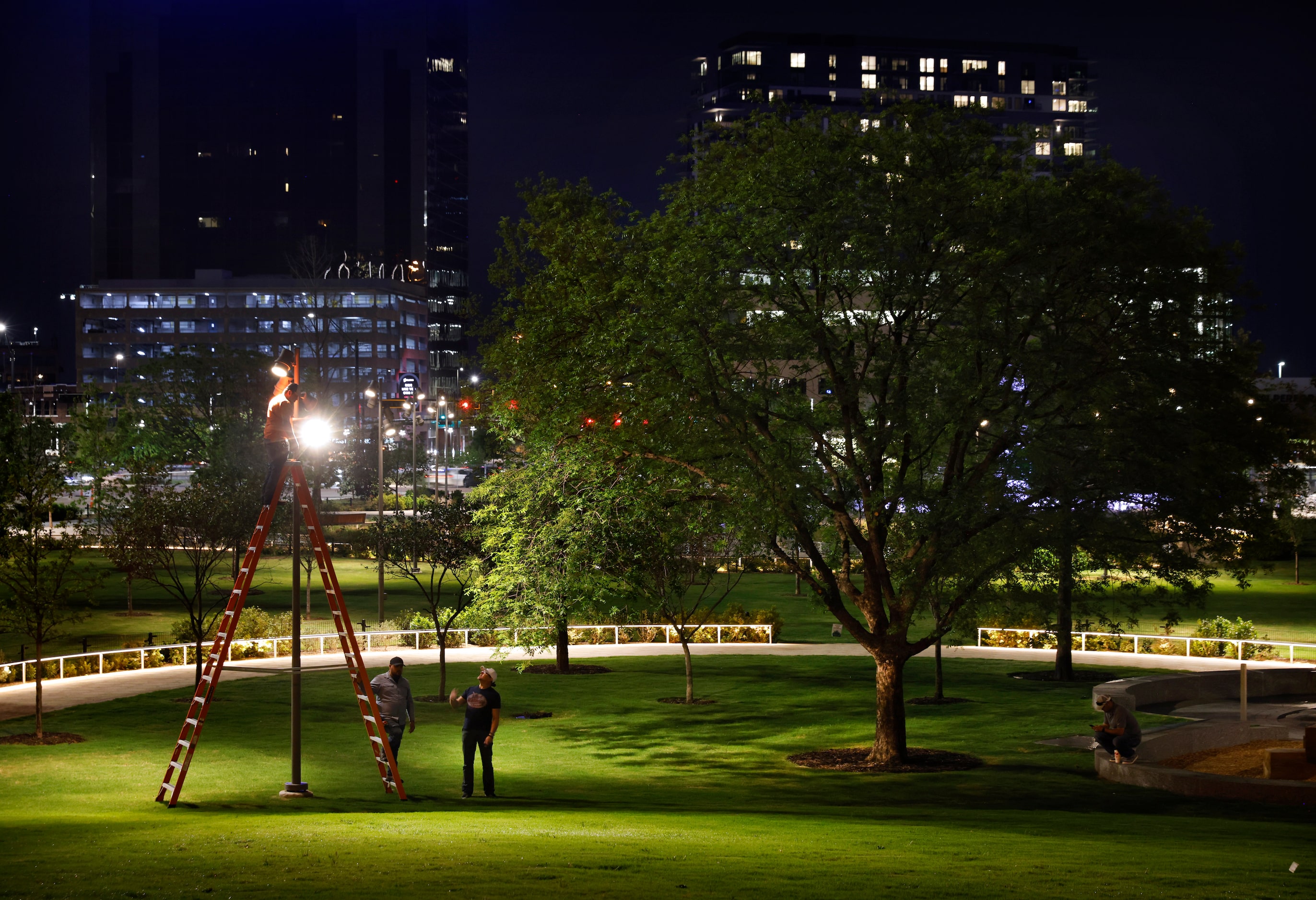 A crew led by Ross Murphy of Oldner Lighting (center, left) adjust spot lights to illuminate...