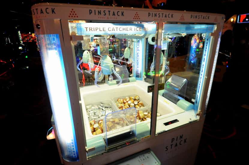 An ice cream claw game at Pinstack challenges players to pick up ice cream treats.
