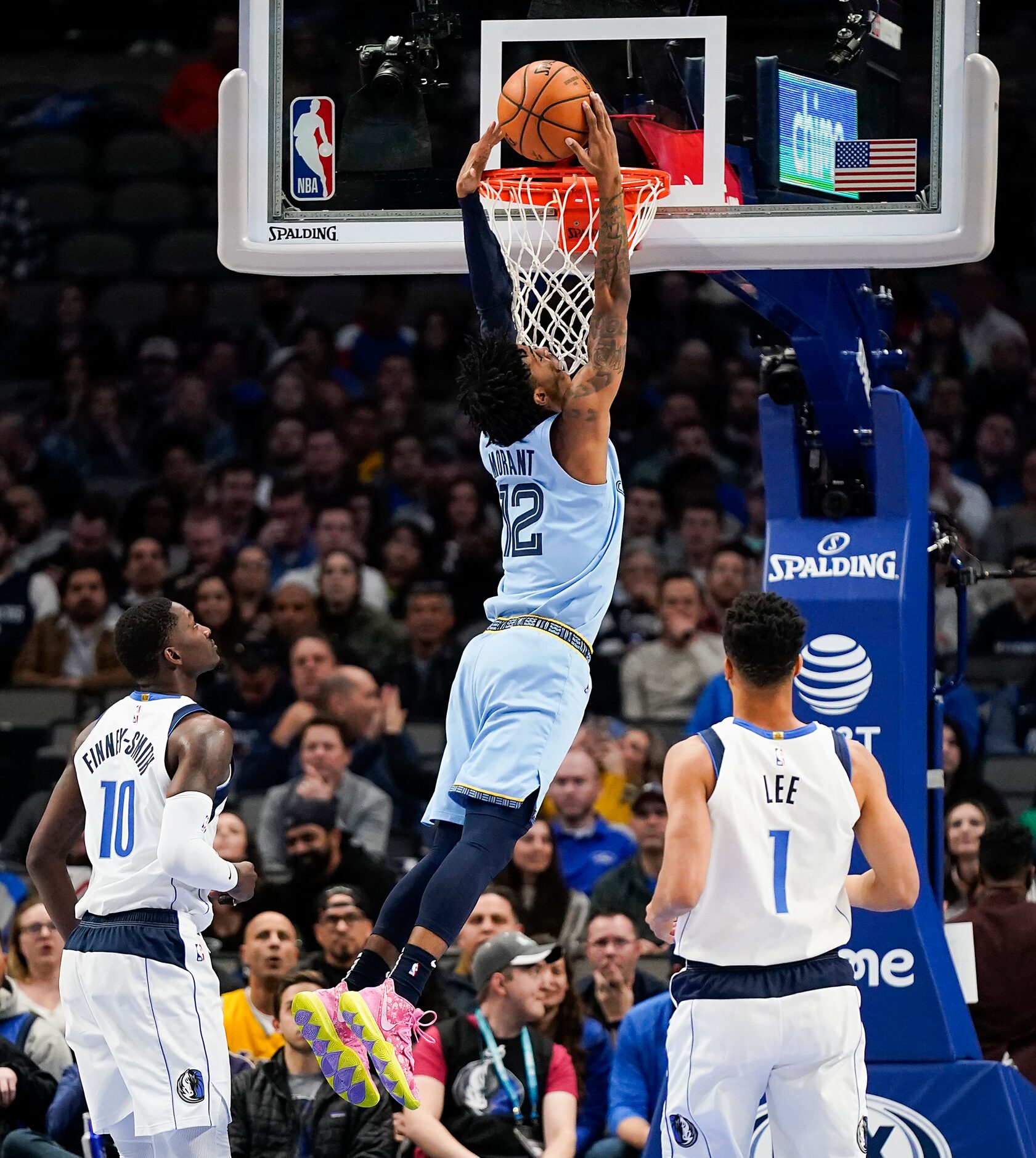 Memphis Grizzlies guard Ja Morant (12) dunks the ball past Dallas Mavericks forward Dorian...