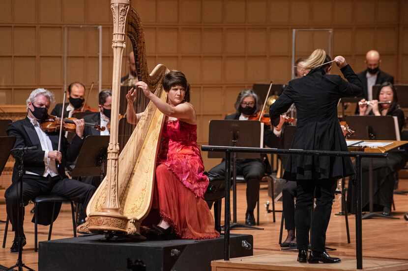 Harpist Emily Levin (left) performs the Harp Concerto by Alberto Ginastera with principal...