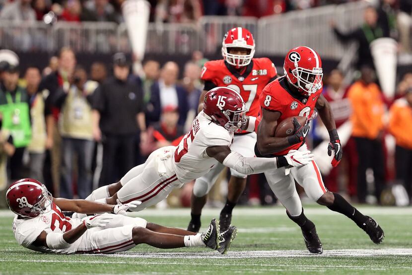 ATLANTA, GA - JANUARY 08: Riley Ridley #8 of the Georgia Bulldogs is tackled by Ronnie...