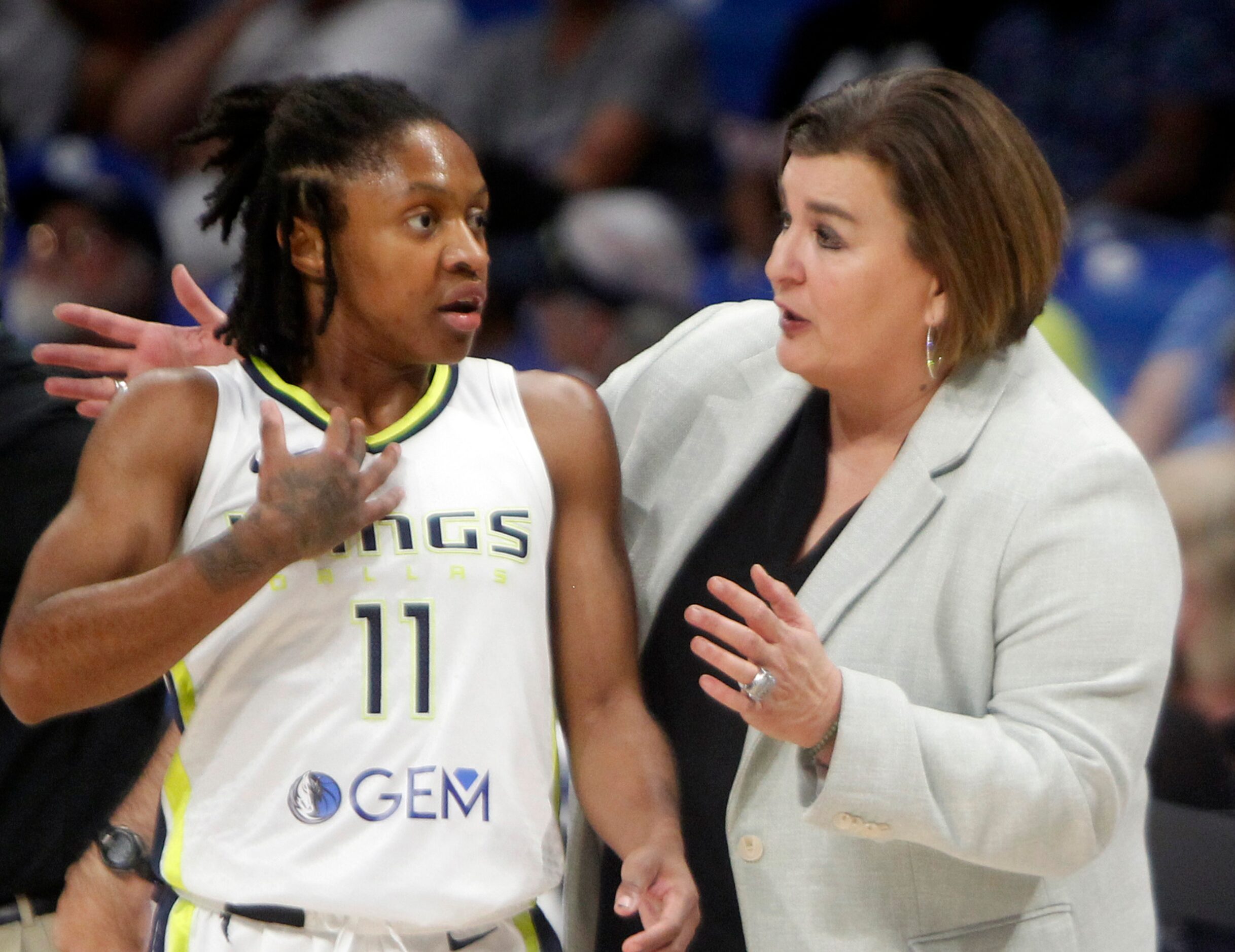 Dallas Wings head coach Latricia Trammell converses with Wings guard Crystal Dangerfield...