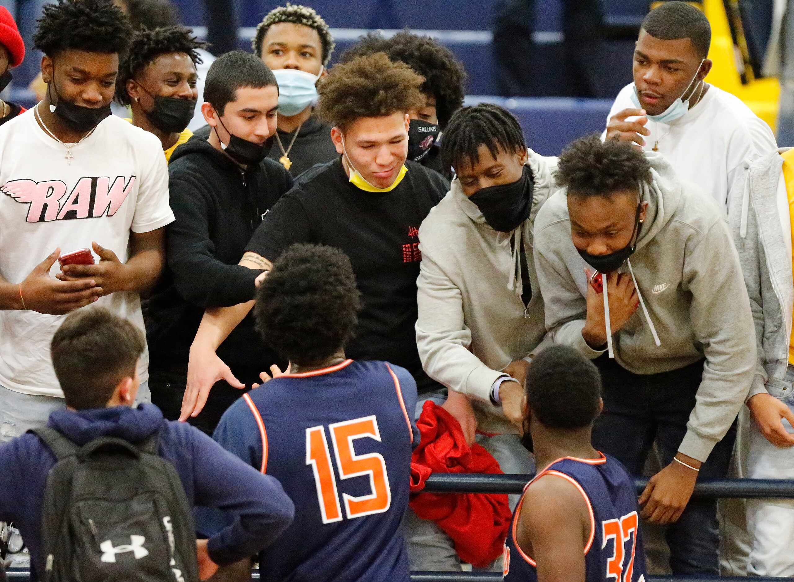 McKinney North High School post Jamien Hopkins (15) is congratulated by students after the...