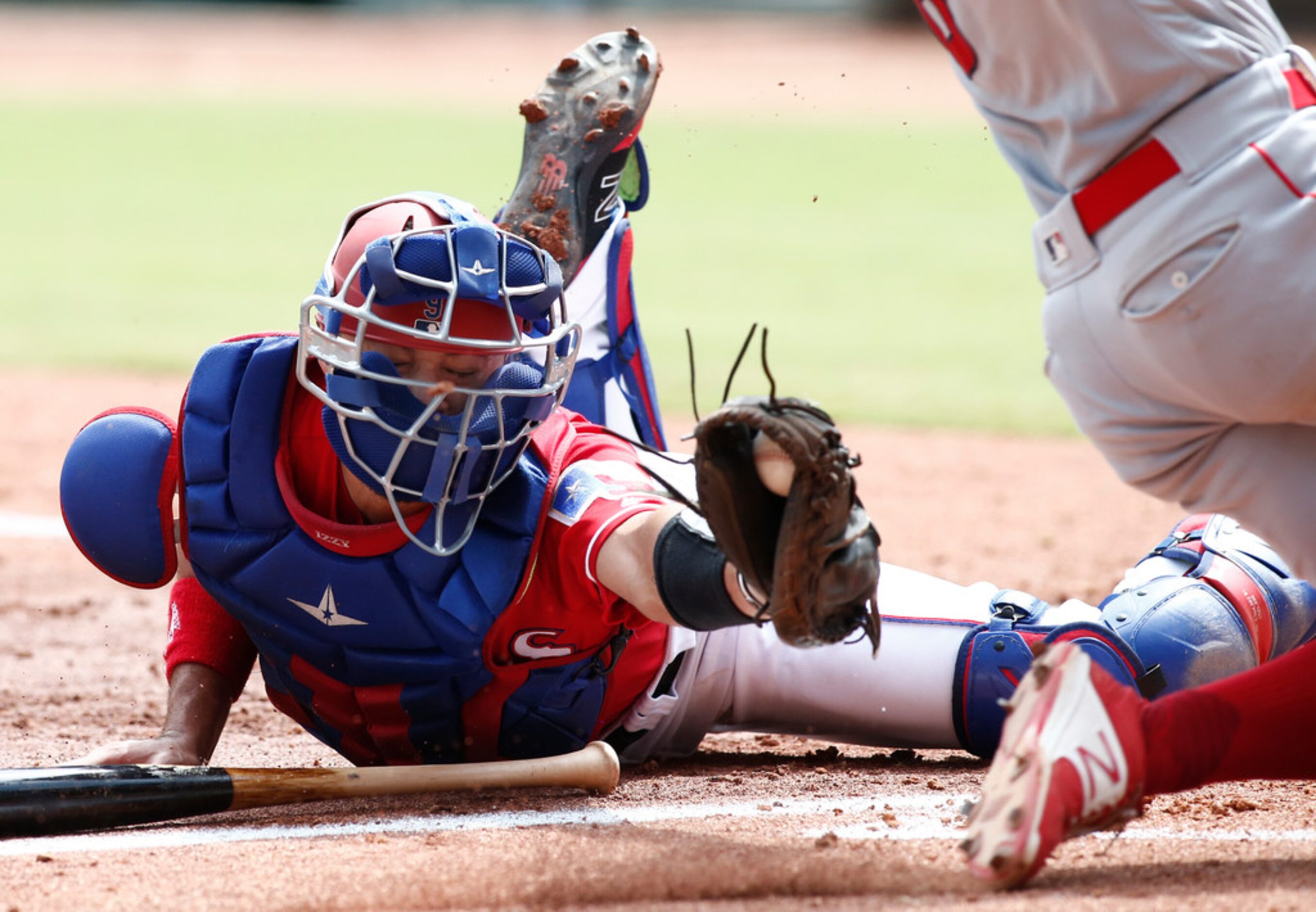 Texas Rangers catcher Isiah Kiner-Falefa, left, is unable to get the tag on Los Angeles...