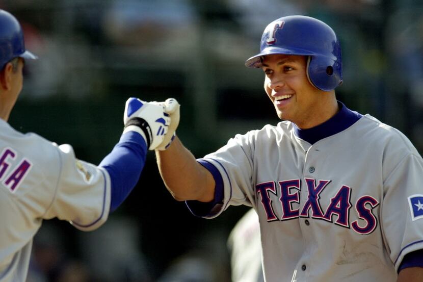 ORG XMIT: S0354635863_WIRE Texas Rangers' Alex Rodriguez, right, is congratulated by...