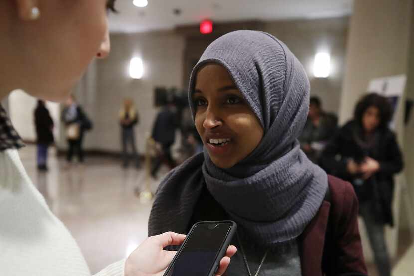 Newly elected U.S. Rep. Ilhan Omar, D-Minn., talks to a reporter before attending a welcome...