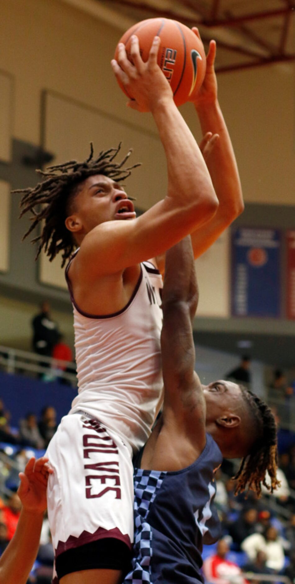 Mansfield Timberview senior Joey Madimba (0) skies over the defense of Putnam City West,...