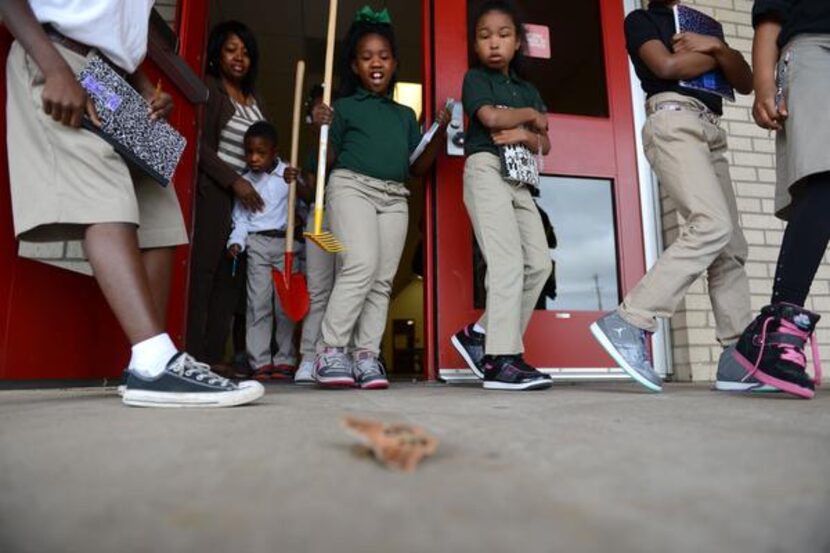 
Second-grade students react to seeing a moth on their way to tend to the outdoor teaching...