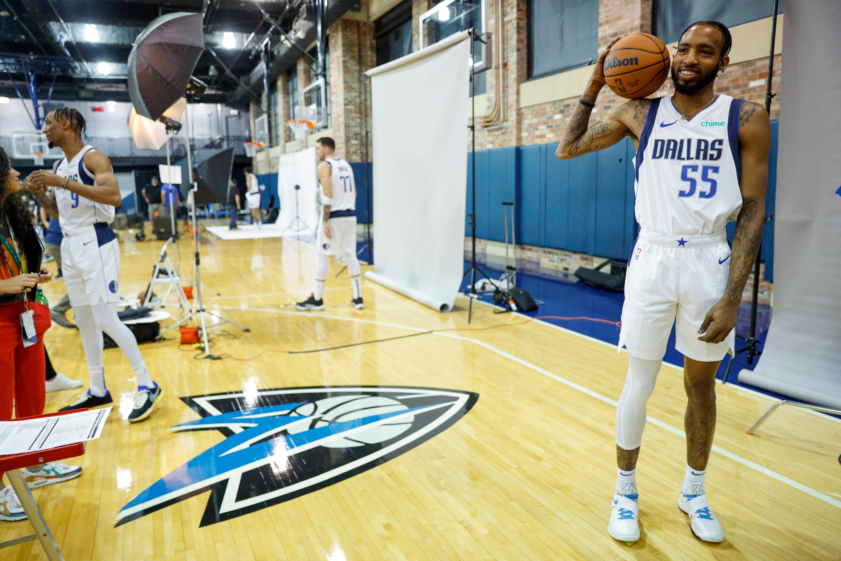 Dallas Mavericks forward Derrick Jones Jr. (55) laughs as he poses during media day at...