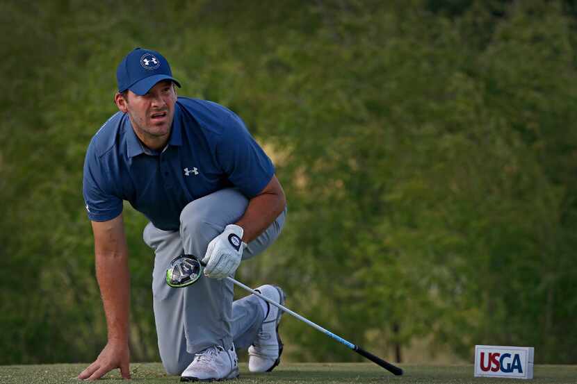 Former Dallas Cowboys quarterback Tony Romo watches his tee shot on the 18th tee box during...