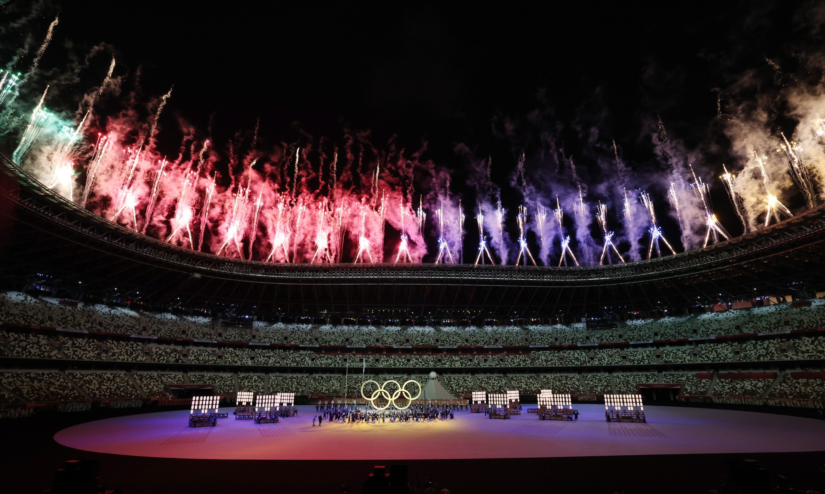 Fireworks go off as the Olympic rings are shown during the opening ceremony for the...