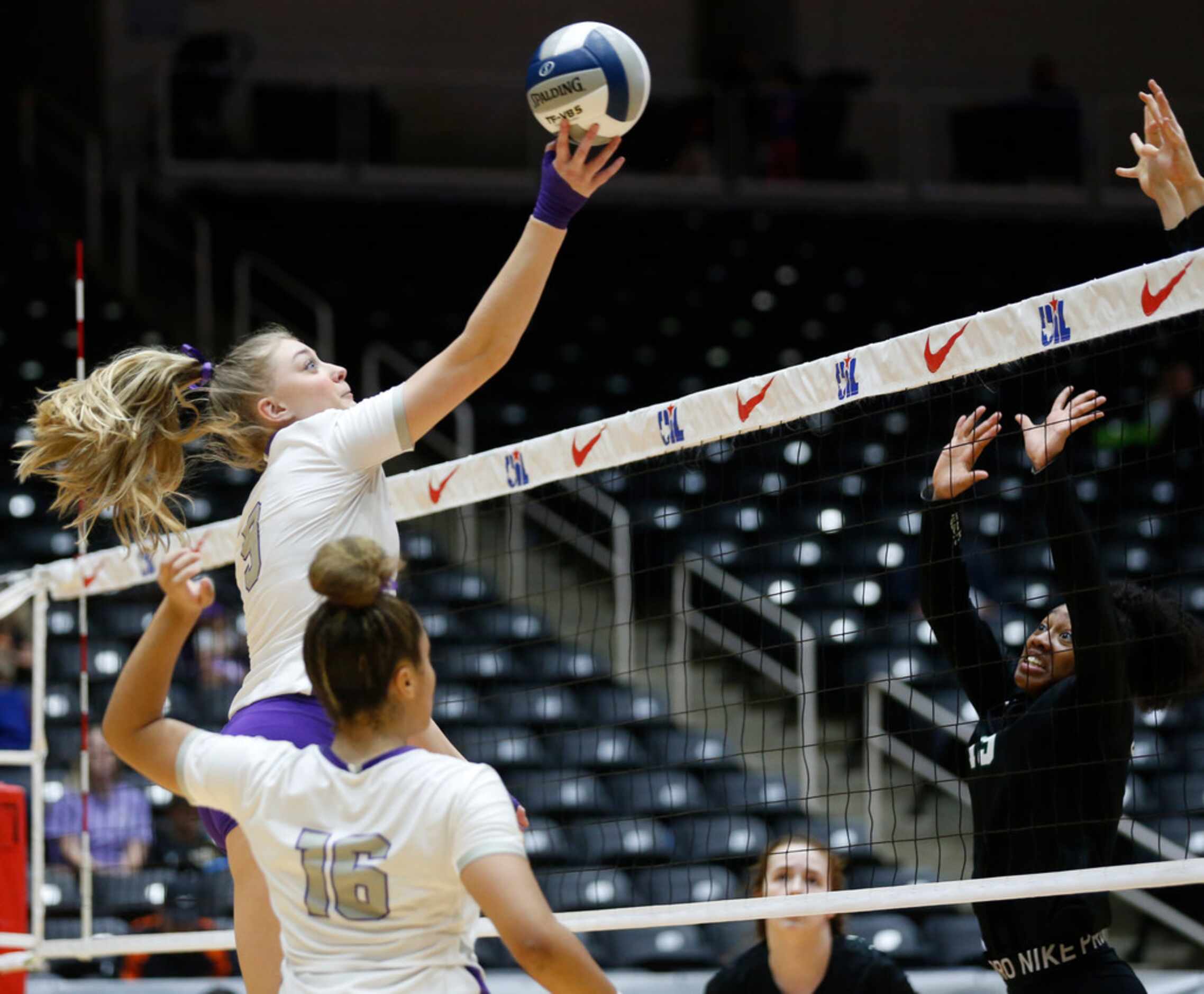 Lamar Fulshear's Skylar Voskuhl (9) hits the ball over Kennedale's Alexandra Youngblood (15)...