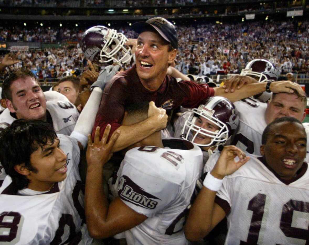 Houston, Texas -  Ennis head coach Sam Harrell is lifted by his players as he watches the...