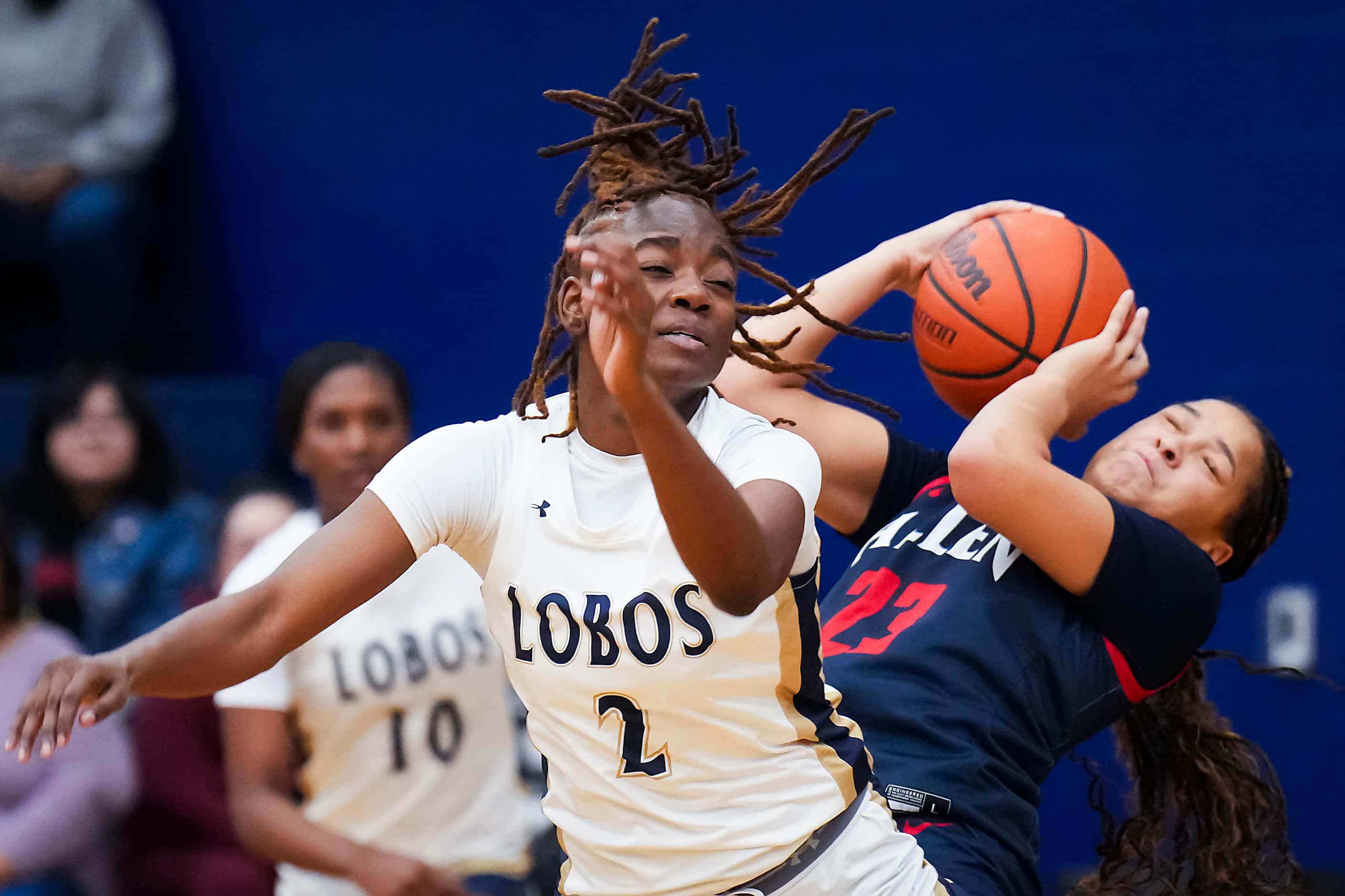 Little Elm's Kam Williams (2) fights for a rebound against Allen’s Aryn Roberts (23) during...