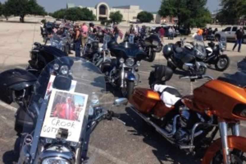  Several bikers posted signs on their motorcycles to protest the 143 people still jailed in...