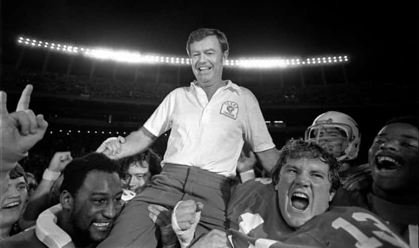 University of Texas Football coach Darrell Royal is carried from the football field...