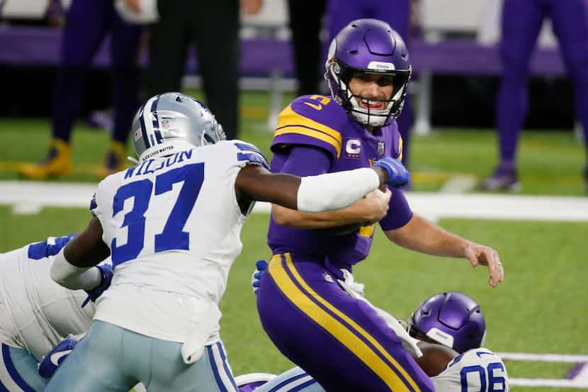 Dallas Cowboys safety Donovan Wilson (37) sacks Minnesota Vikings quarterback Kirk Cousins,...