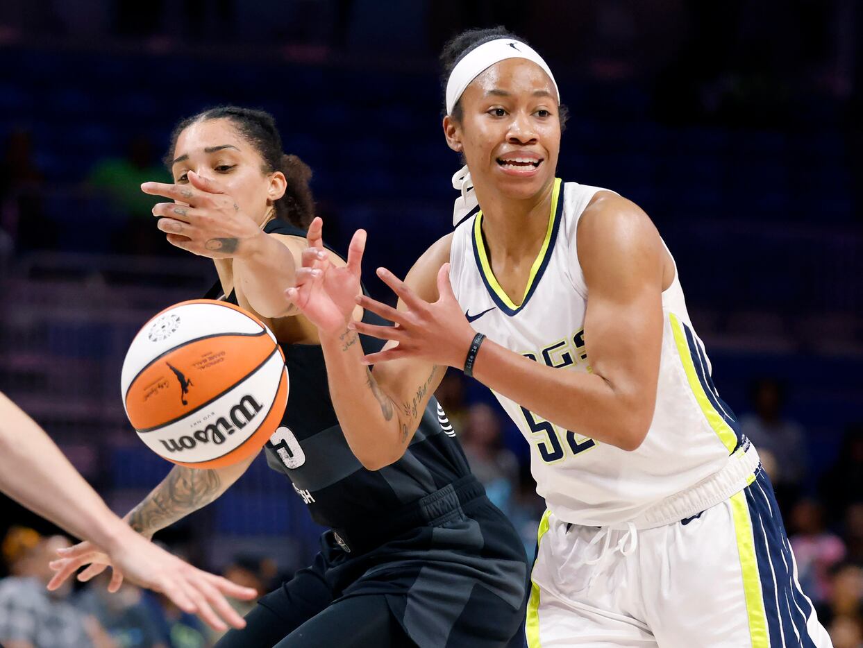 Dallas Wings guard Tyasha Harris (52) has the ball tipped out of her hand by Seattle Storm...