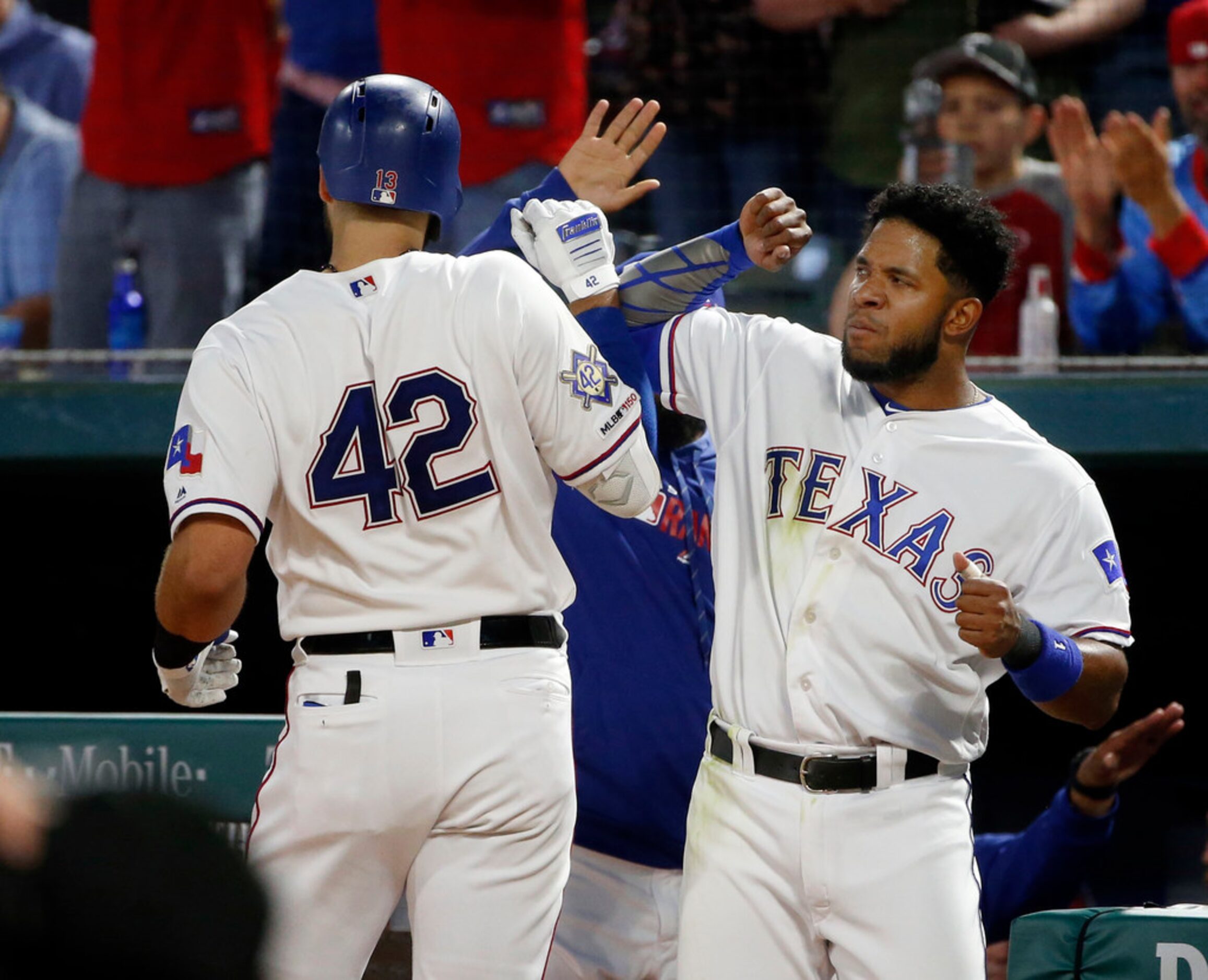 Texas Rangers' Joey Gallo, left, is congratulated by Elvis Andrus, right, after hitting a...