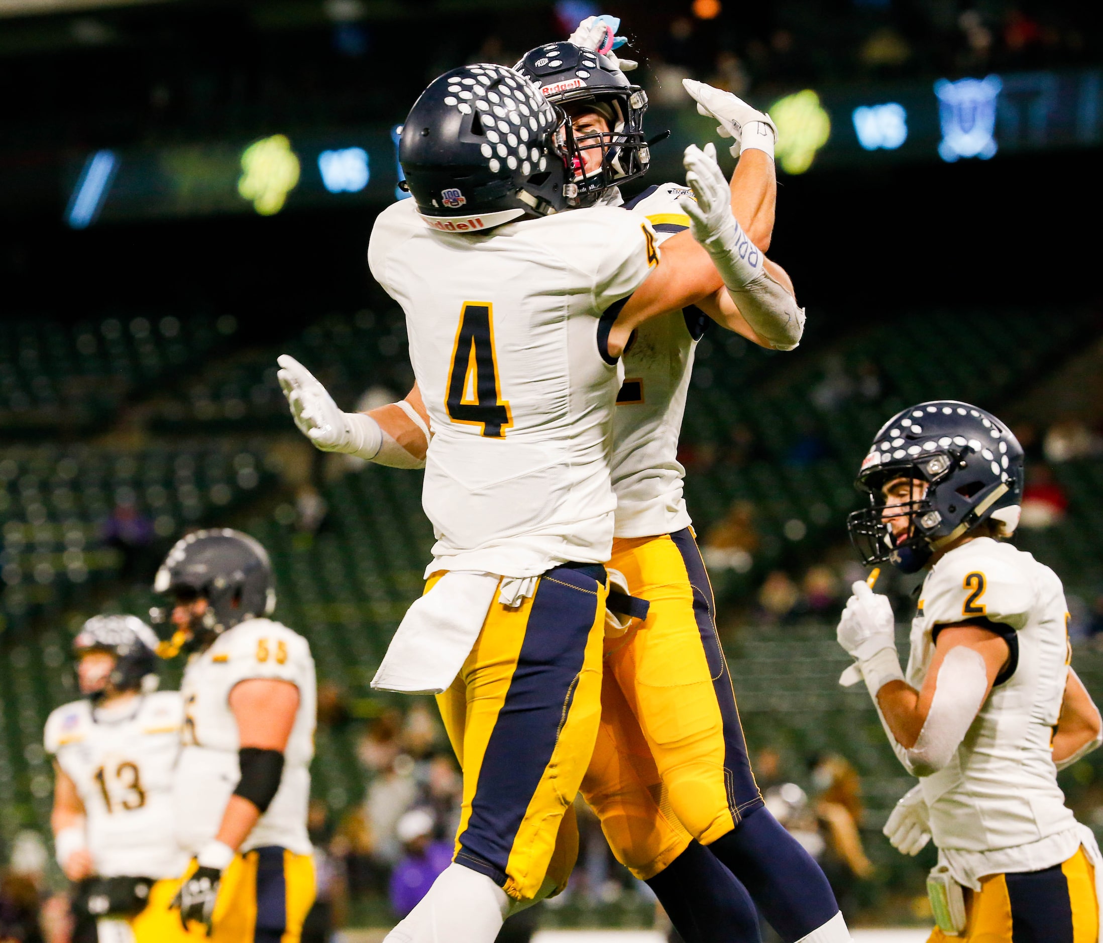 Highland Park's Crockett Corwin (4) celebrates Brooks Bond's (22) touchdown in the fourth...