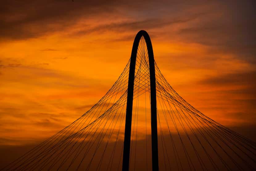 The lingering colors of sunset silhouetted the Margaret Hunt Hill Bridge in Dallas on June...