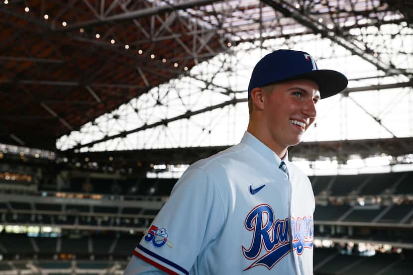 Brock Porter, Texas Rangers fourth-round draft pick in 2022, talks with media in August 2022...