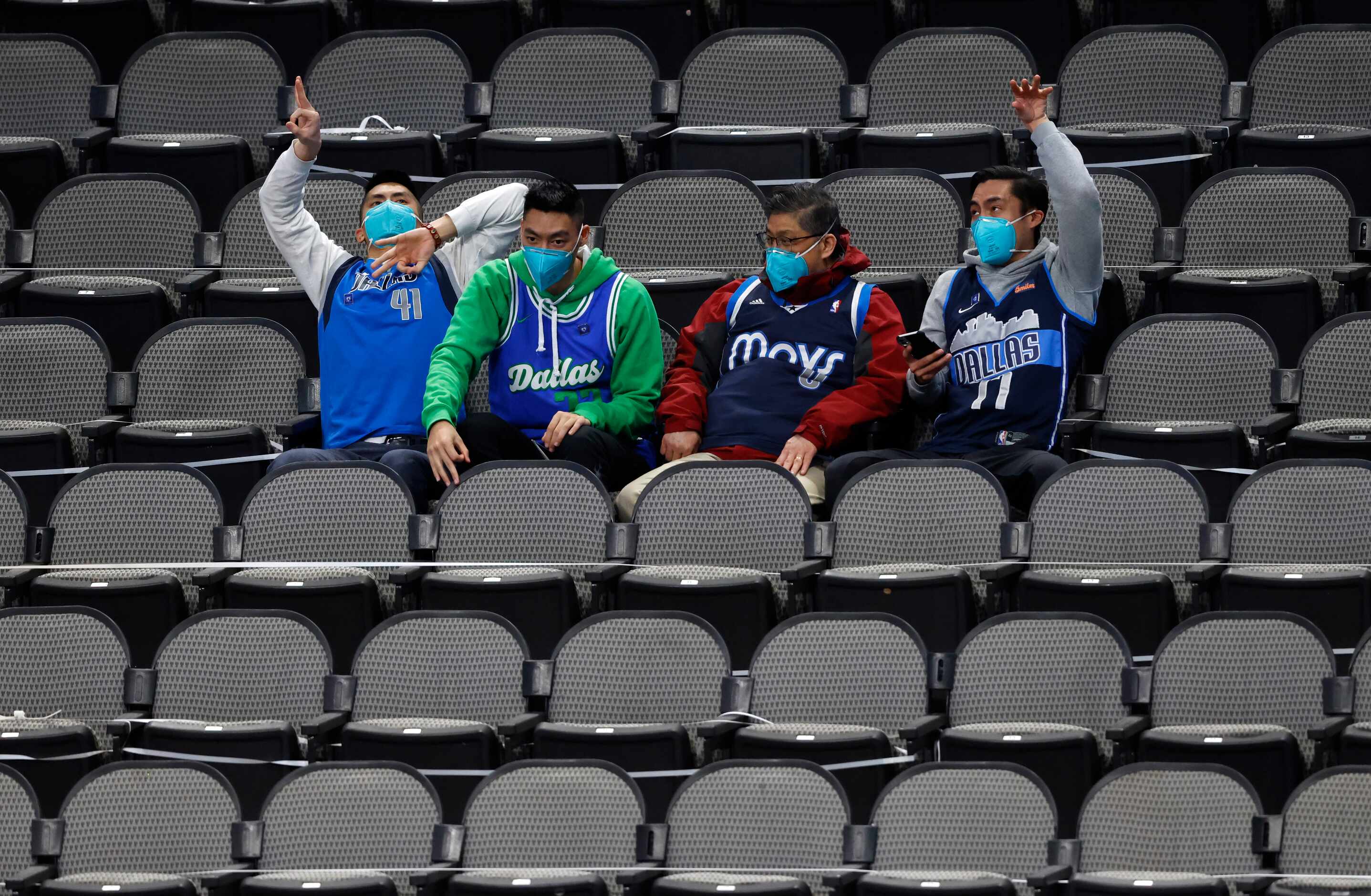 Dallas Mavericks fans celebrate a made basket as they play against the Minnesota...