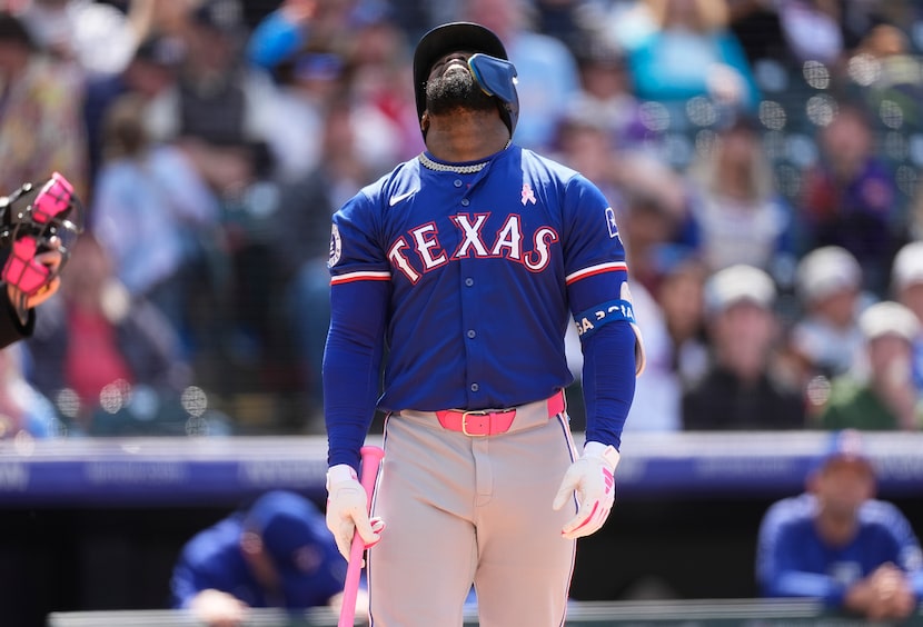 Texas Rangers' Adolis García reacts after popping out against Colorado Rockies relief...