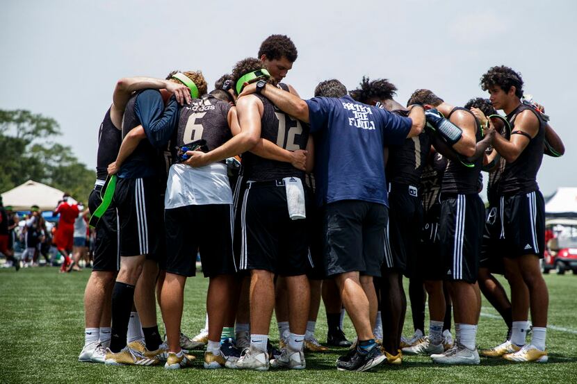 Fort Worth All Saints players an coaches huddle after a loss to Clear Brook during a...