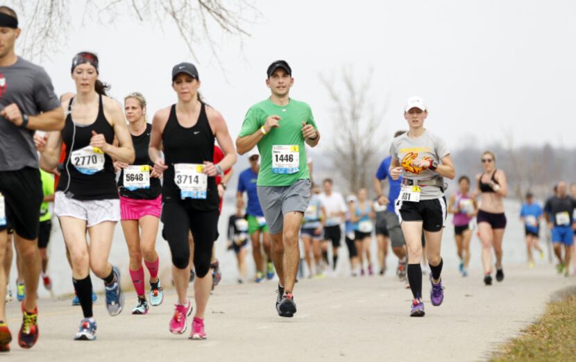 Runners make their way through White Rock Lake during the MetroPCS Dallas Marathon in Dallas...