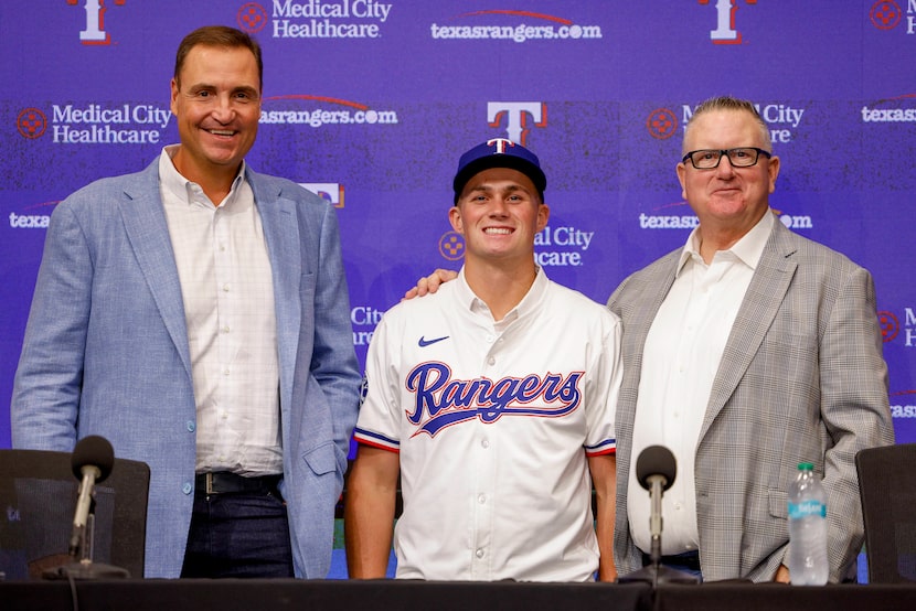 Texas Rangers general manager Chris Young (left), first-round pick Malcolm Moore (center)...