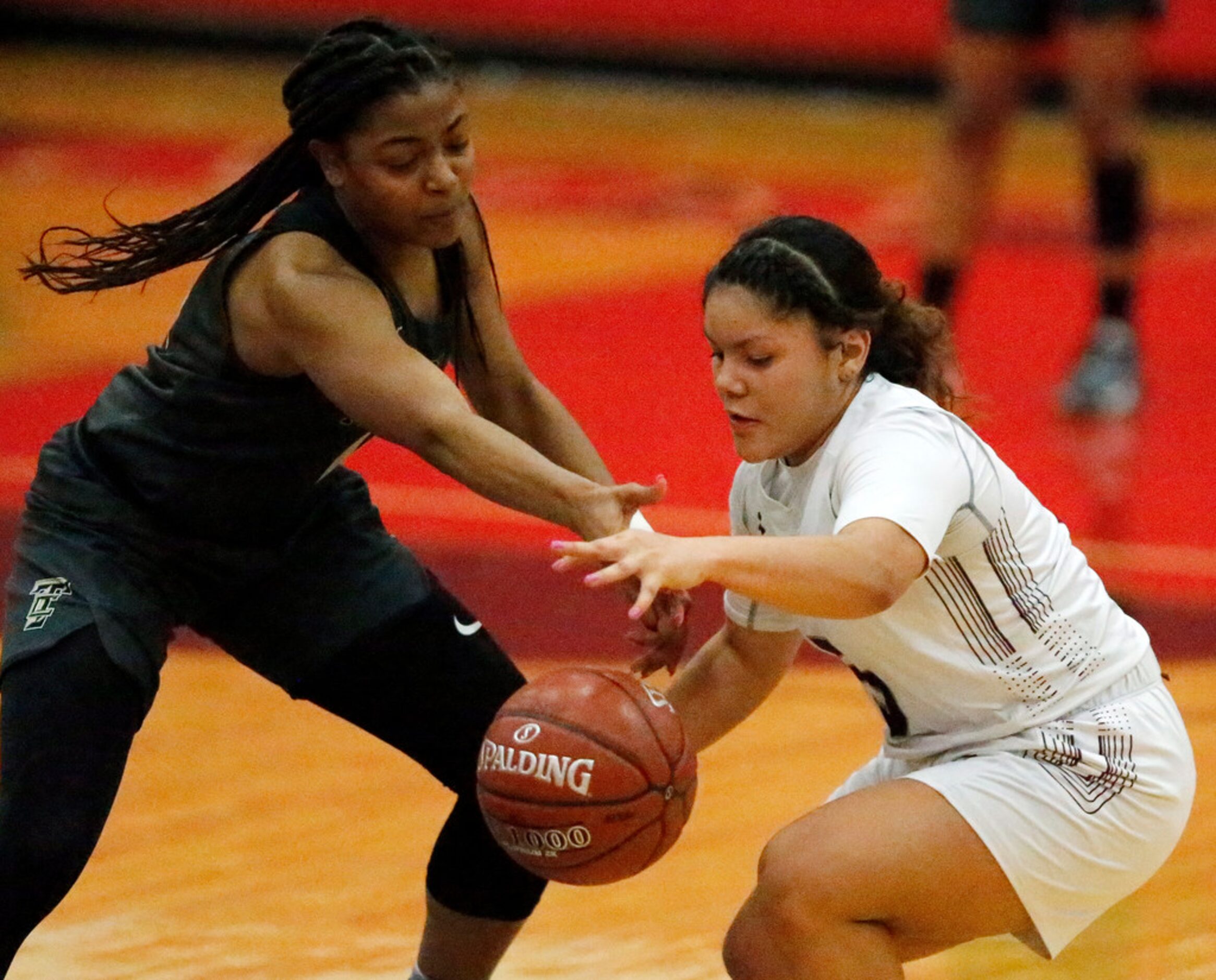 The Colony High School guard Tamia Jones (14) and Timberview High School guard Nina Milliner...