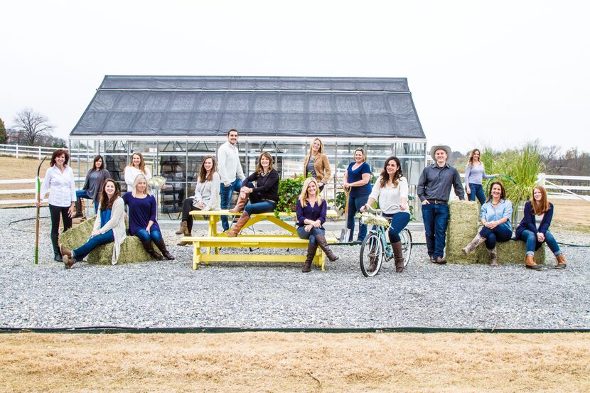 Shannon McLinden (seated on the table in the middle) is surrounded by staff at the McKinney...