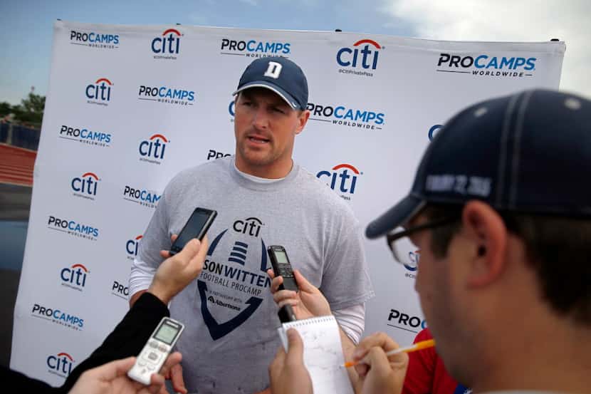 Dallas Cowboys tight end Jason Witten (center) takes a break to answer media questions...