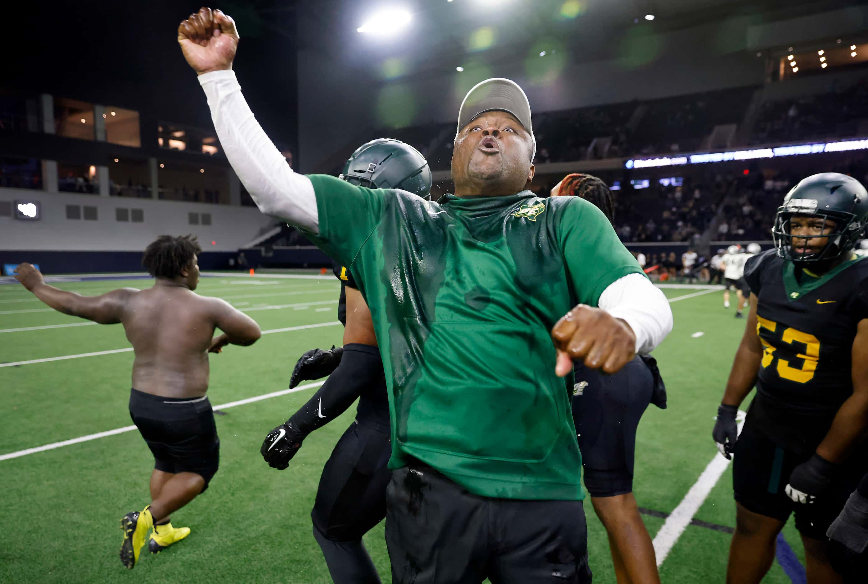 DeSoto head coach Claude Mathis and his players celebrate their Class 6A Division II state...