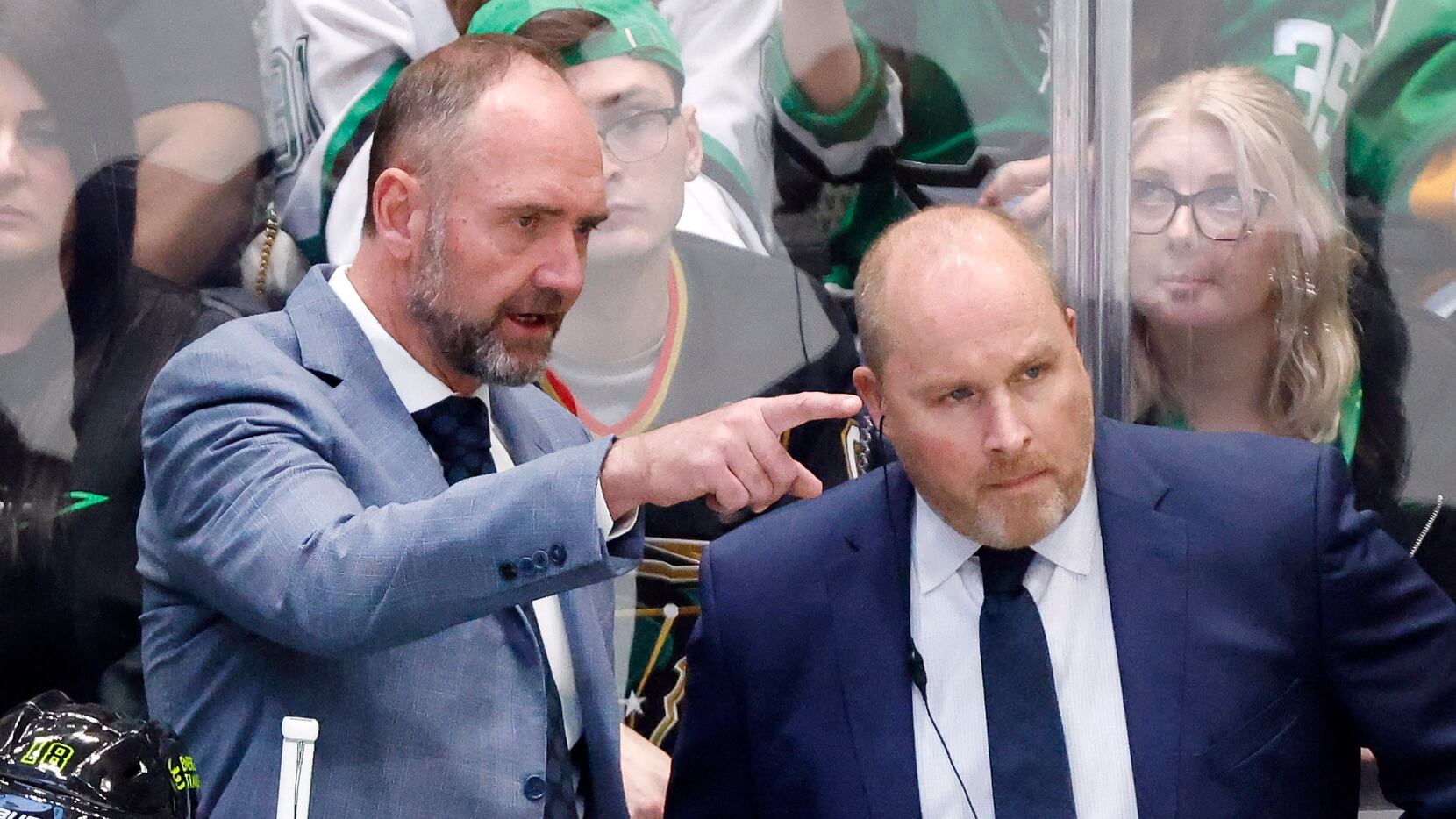 Dallas Stars head coach Pete DeBoer (left) confers with assistant Steve Spott during the...