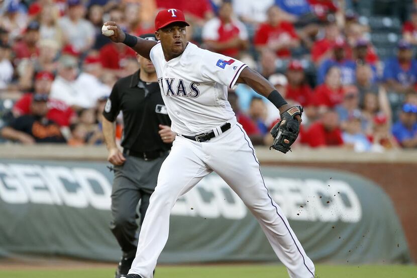 Rangers third baseman Adrian Beltre throws the ball to first to complete a double play...