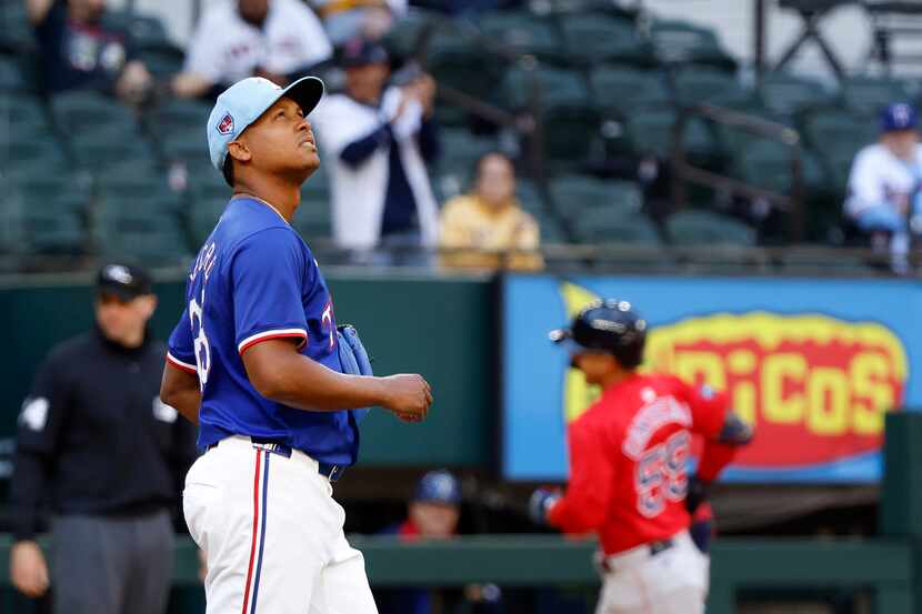 Texas Rangers relief pitcher Jose Leclerc looks to the video board as Boston Red Sox batter...