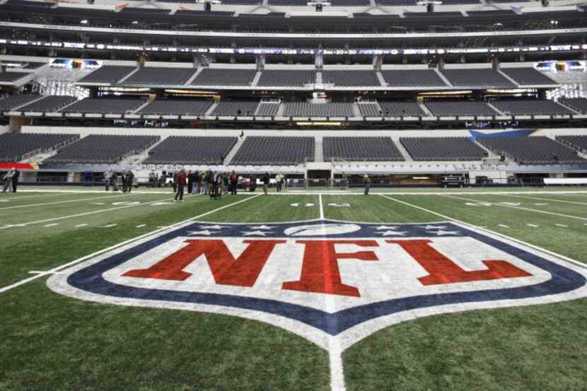 The NFL logo, painted at midfield as crews worked to prepare Cowboys Stadium in Arlington,...