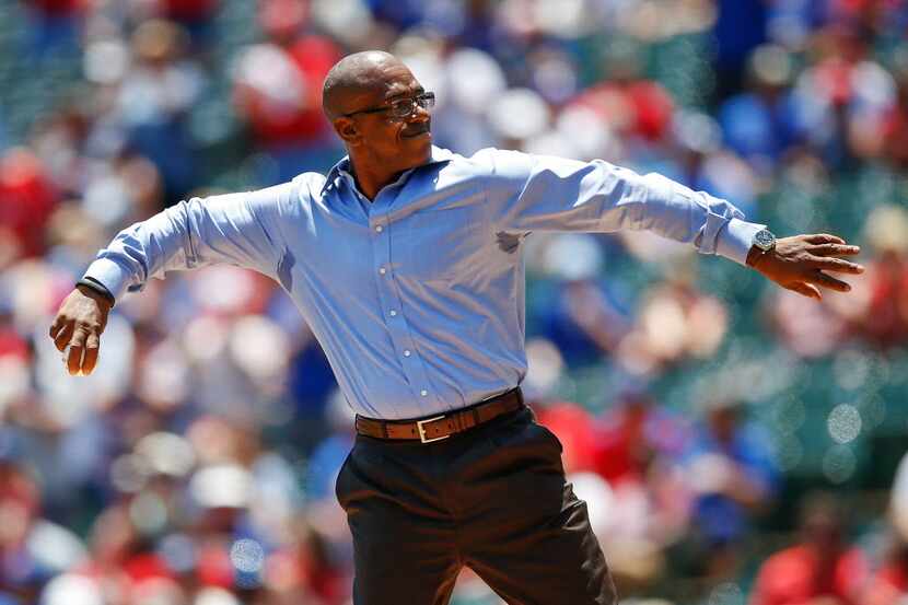 Former Texas Rangers player Julio Franco throws out the ceremonial first pitch before the...