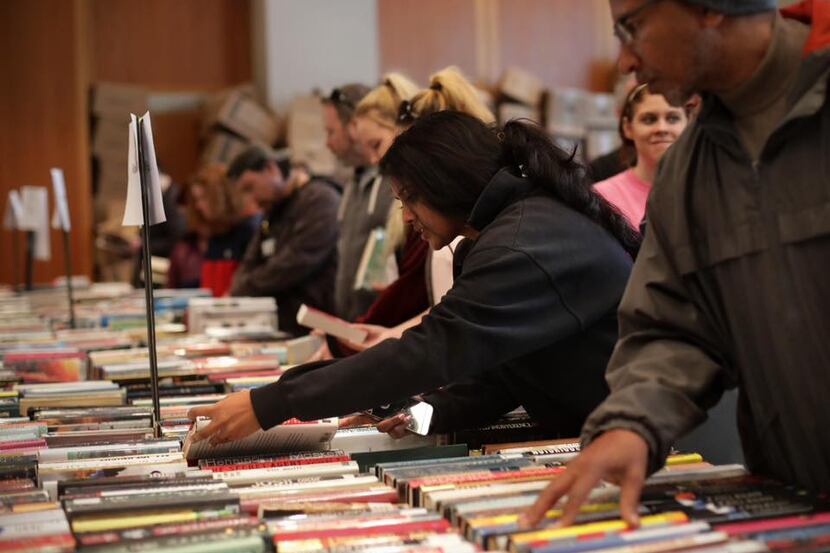 Customers go through books and other media that were on sale in the January book sale hosted...